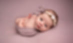 Photo of newborn baby girl on pink looking at camera by Specialist Newborn Photographer, Hull and East Yorkshire and North Lincolnshire