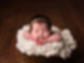 Image of newbon baby posed in wooden bucket on white wool stuffer by Specialist Newborn Photographer, Hull and East Yorkshire and North Lincolnshire