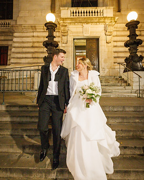 Happly Married couple comind down the stairs from City Hall