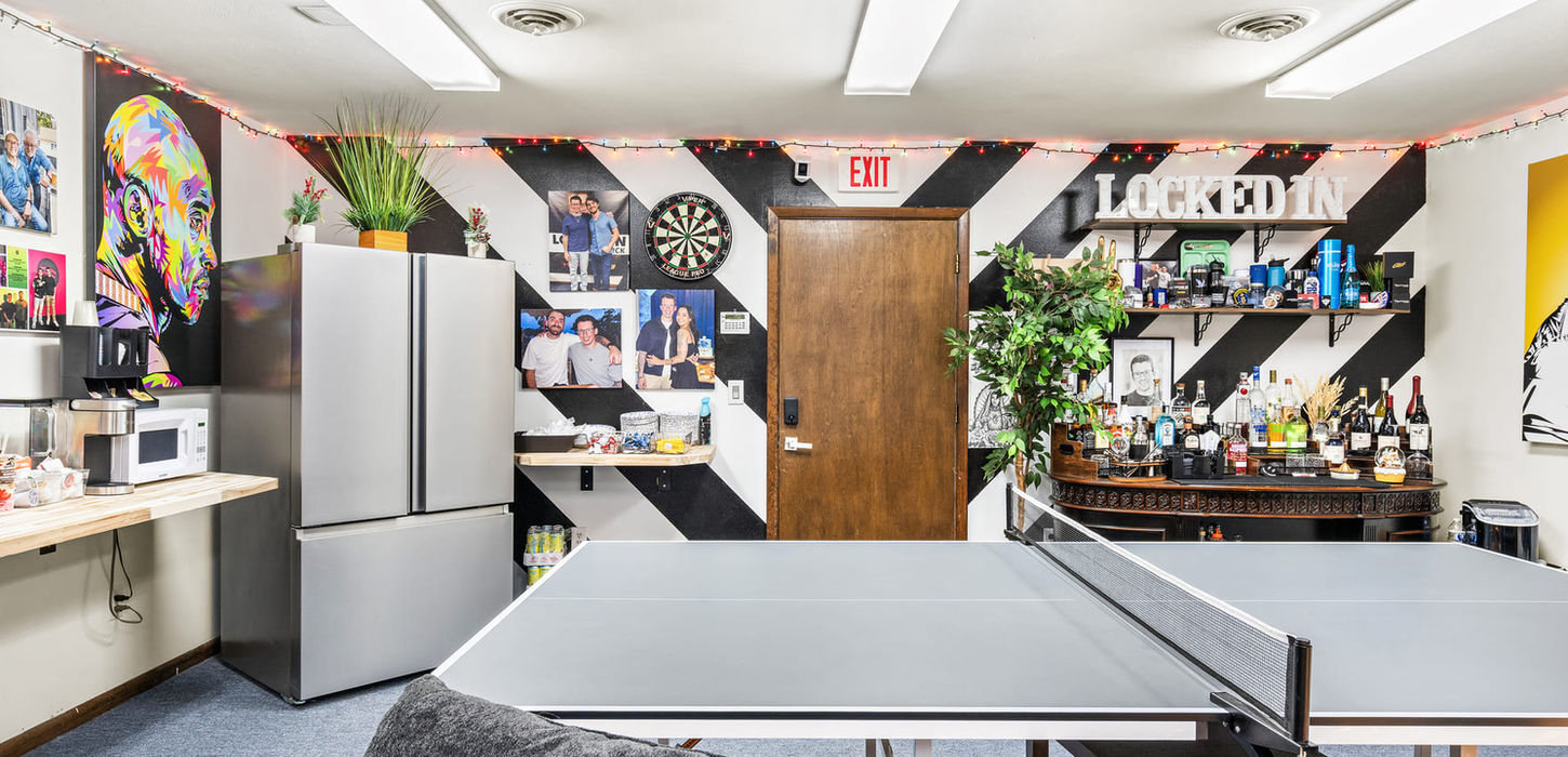 Centered view of the ping pong table inside the Locked In With Ian Bick recreation and lounge space.