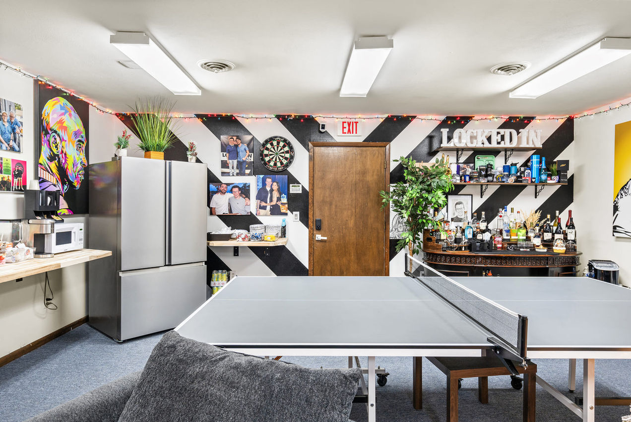 Centered view of the ping pong table inside the Locked In With Ian Bick recreation and lounge space.