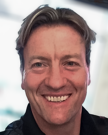 Head shot of founder Chris Hunter smiling with short light brown hair.