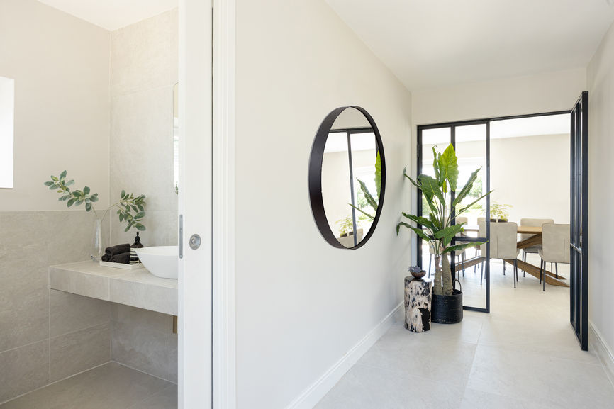 Bespoke metal-framed glazed doors leading into the open-plan living space