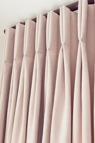 Dusty pink double pinched designer curtains on bronze metropole