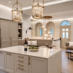 Kitchen island with glass pendant lights, a sitting area and an arched glazed door at The Vault, Alderley Edge, Cheshire.