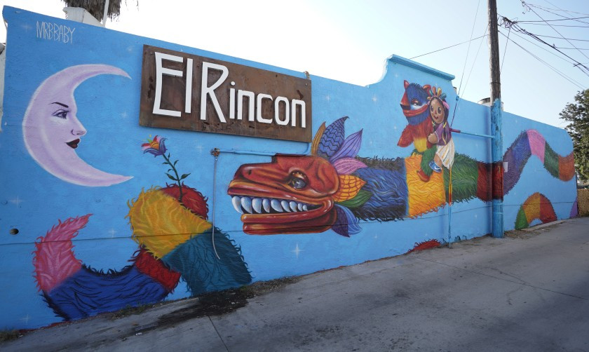 Artist Michelle Guerrero, also known as Mrbbaby, recently finish this mural, called “Quetzalcoatl falls in love with the moon” at El Rincón Restaurant.(Alejandro Tamayo/The San Diego Union-Tribune)