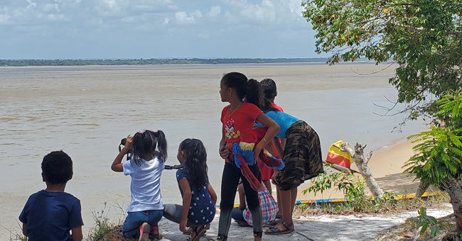 Children observing parrots from their village in Guyana