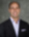 Ernie Grigg's headshot. He is wearing a blazer and pocket square