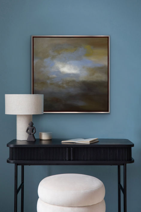 80x80cm acrylic painting titled "Held",part of an atmospheric series, features an astract cloudy sky in soft,blended gradients.Dominated by earthy browns,creamy beiges and golden yellows at the base,it transitions into swirling teal blues and glowing whites at the center,evoking mist,motion and emotional containment.The textured surface on neutral gray background suggests ethereal suspension amid turbulent forms.