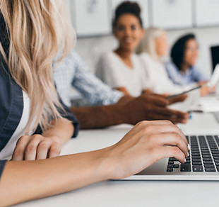 blonde-woman-with-elegant-hairstyle-typing-text-keyboard-office-indoor-portrait-internatio