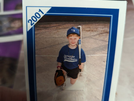 A handsome young boy with a softball uniform from 2001