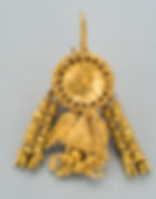 A golden earring with a circular top with two tassels and a eagle hanging below it.