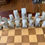Thumbnail: Chess board with marble pieces / players