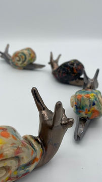 a line of small colorful ceramic garden snails
