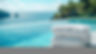 white-towels-stacked-beside-tranquil-pool-overlooking-scenic-ocean-view.jpg