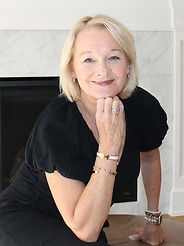Rosie Gunther-McCooe, rental specialist at The Gill Group, leaning on a fireplace