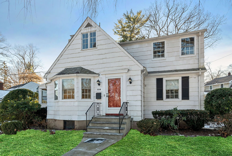 Exterior view of a charming Ridgewood two-story home near the Willard School district, surrounded by a well-kept lawn and landscaping.