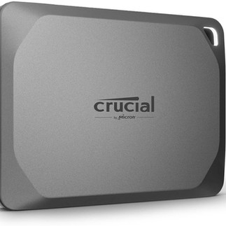 Einzelaufnahme einer portablen Crucial SSD in grauem Gehäuse. Sichtbare Materialtextur und sanfte Kurven.