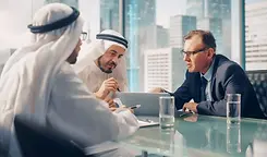 Arab-and-Western-businessmen-in-meeting-Shutterstock-scaled.webp