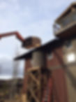 Specialty construction of western-style water tank on raised platform connected to side of barn