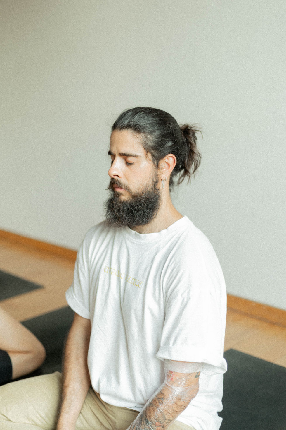 Hombre meditando en clase de yoga