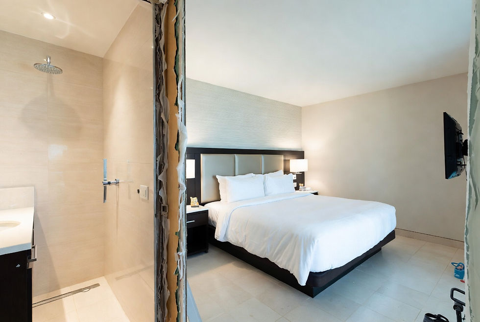 Modern hotel guest room and bathroom renovation during a Property Improvement Plan (PIP), showing updated high-end finishes and quality construction work