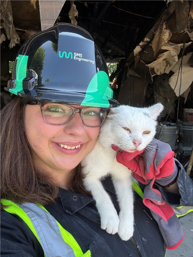 Melanie from SMS Forensics is posing with a cat from a fire scene