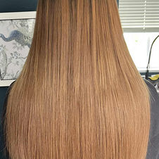 Hair transformation with copper weave extensions, adding bold volume, vibrant colour, and luxury.