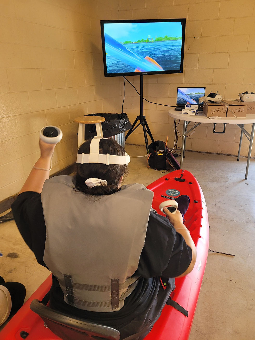 A participant at the entertainment village enjoying the virtual kayaking experience.