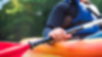 older woman holding kayak paddle