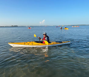 man with visual impairment and paralysis in an adapted kayak on the water