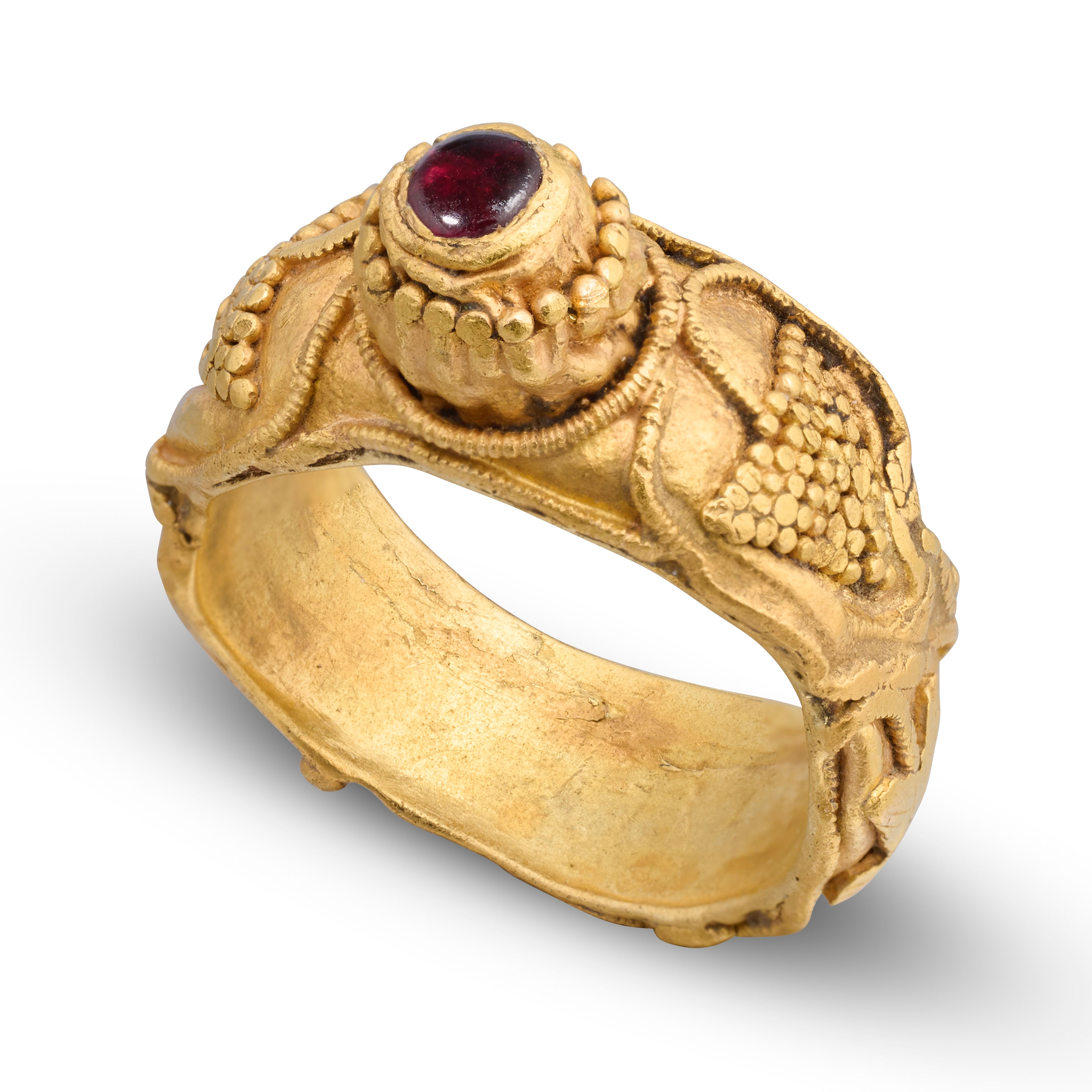 Gold ring with grapes and a cabochon garnet. Merovingian, 6th century AD.