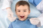 small male kid having his dental inspection