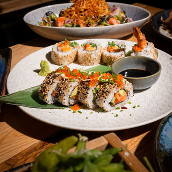 Inside-out sushi rolls with tobiko and soy sauce
