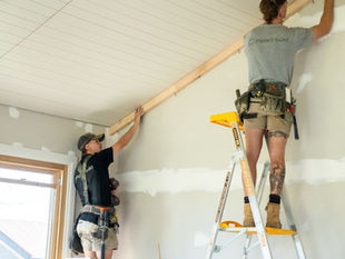 Two employees from Impact Build are working on building the interiors of a recent project in the Macedon Ranges.