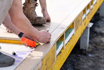 Luke from Impact Build measuring on site of a new local build in the Macedon Ranges