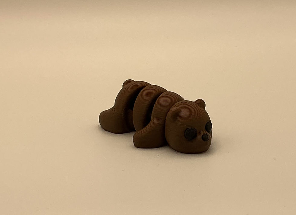 Brown 3D printed articulated bear fidget toy on table