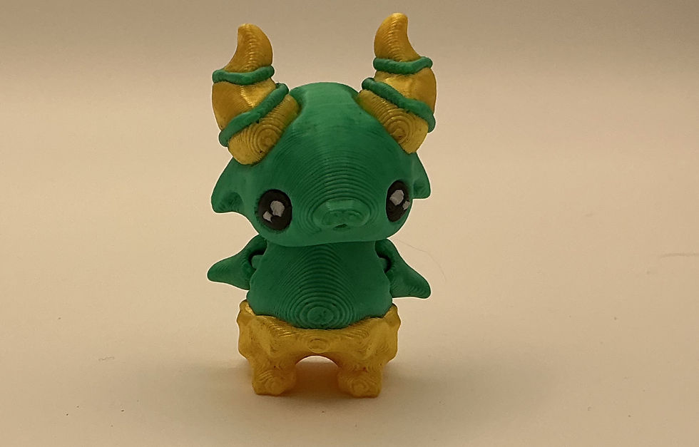 3D printed fantasy creature mini with horns in green and gold, cute collectible figure