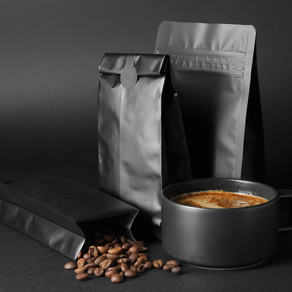 Freshly roasted coffee beans pouring from flexible packaging bag