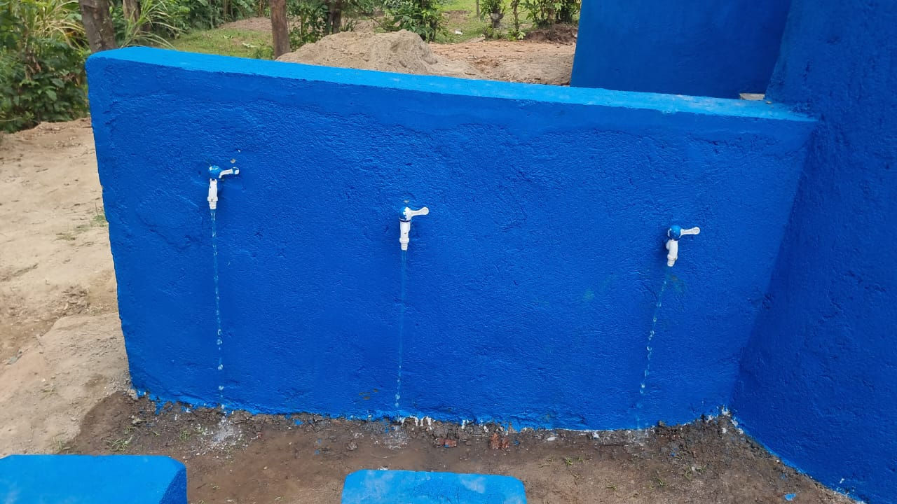 Three water taps on a blue wall