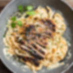 Blackened Chicken on bed of fetuccini Alfredo sauce