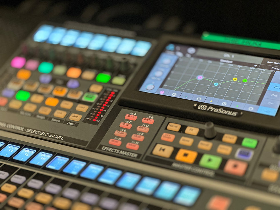 Close-up of PreSonus digital audio mixer with EQ interface and illuminated controls.