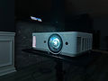 ViewSonic short-throw projector powered on during an indoor video playback.