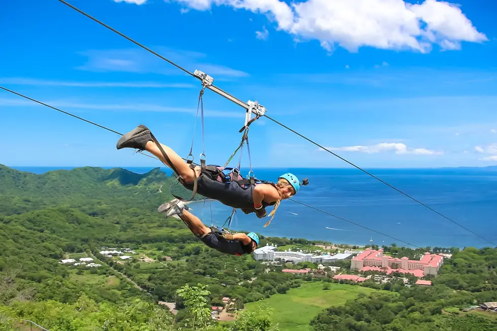 Adventurers ziplining with an ocean view on Costa Rica’s longest zipline during the Combo Tour by Salty Smile Surf.