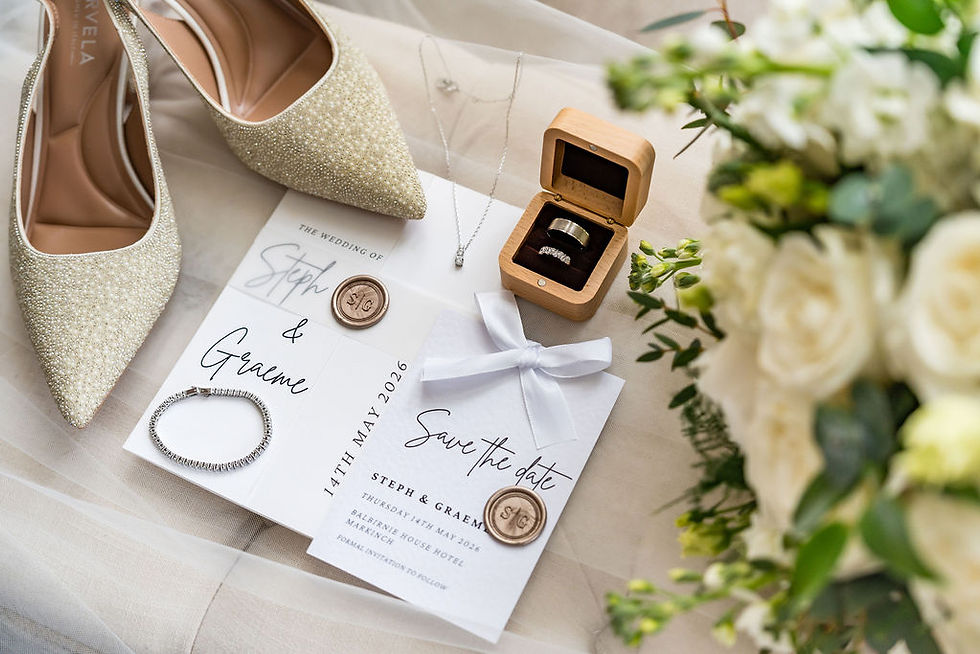 Wedding details including invitation, shoes and flowers photographed during bridal preparations at Balbirnie House in Scotland.