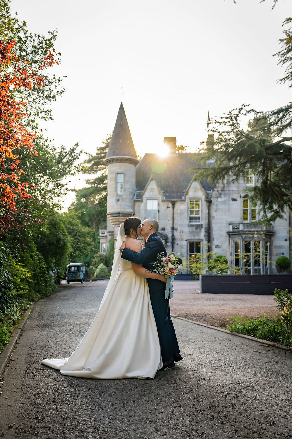 Bride and groom sharing a romantic kiss in front of Taypark House during their Dundee wedding, captured by Dundee wedding photographer ZibiZ Photo.