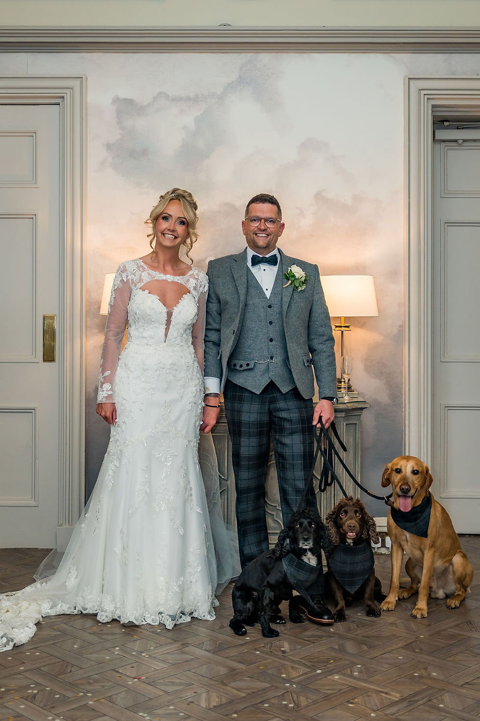 Newlywed couple posing with their dogs outside Balbirnie House during relaxed Scottish wedding portraits