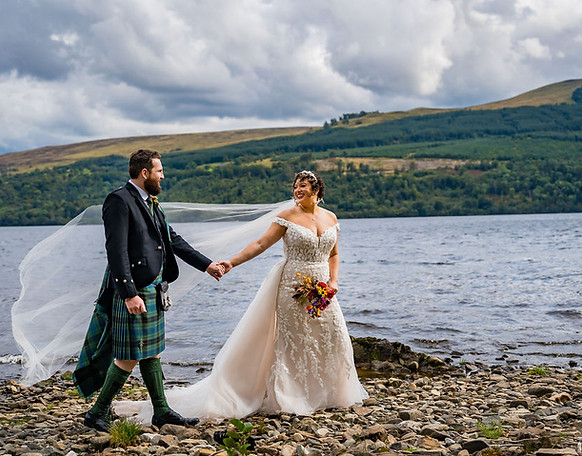 Romantic wedding portrait of bride and groom captured by a Scottish wedding photographer at Boreland Loch Tay, with sweeping views of Loch Tay and the Highland mountains in the background. Natural and candid wedding photography in Scotland, perfect for couples looking for Dundee, Angus, and Scottish Highlands wedding venues.