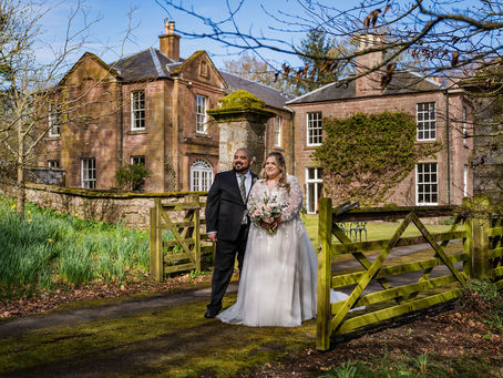 Classic bride and groom portrait with Bardmony Estate in the background, elegant Angus wedding photo