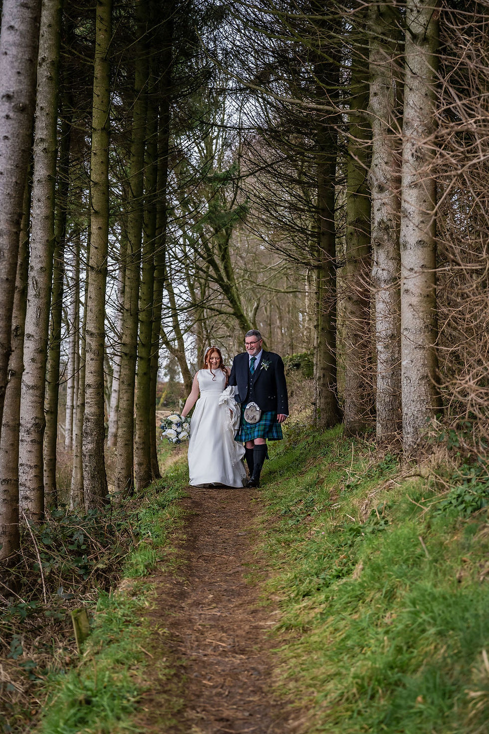 Bride and groom walking together during wedding portraits at Forbes of Kingennie wedding venue near Dundee in Angus, Scotland.